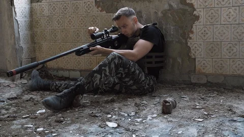 Sniper is preparing a rifle. airsoft. 4k Stock Footage 124706376