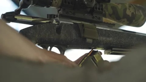 The sniper is reloading his rifle. Close-up Video stock 246065587