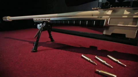 Sniper riffle on table Stock Footage 66111594