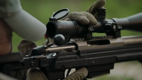 Sniper rifle. Hunter adjusts the scope. Stock Footage 107411591