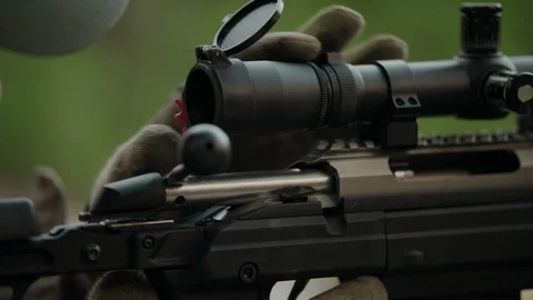 Sniper rifle. The hunter opens the scope. Stock Footage 107410820