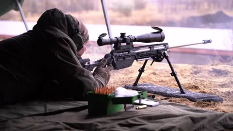The sniper takes aim and makes a shot Video stock 228053171