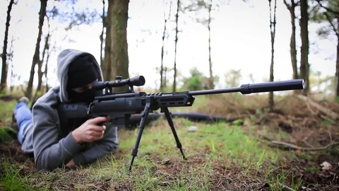 Sniper takes the shot, lying on the forest floor Stock Footage 75070655