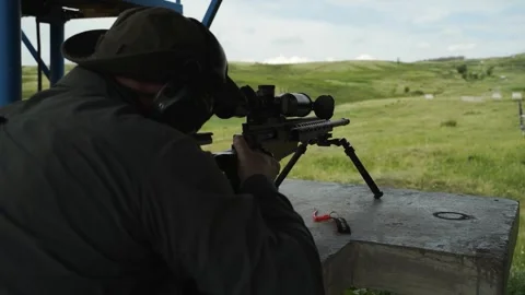 Sniper training at the shooting range. The shooter reloads the sniper rifle Stock Footage 246189743