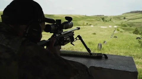 Sniper training at the shooting range. The sniper makes a shot Stock Footage 246791456