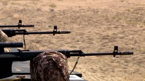 The snipers are lying in a row and shooting from Russian sniper rifles, close-up Video stock 216982494
