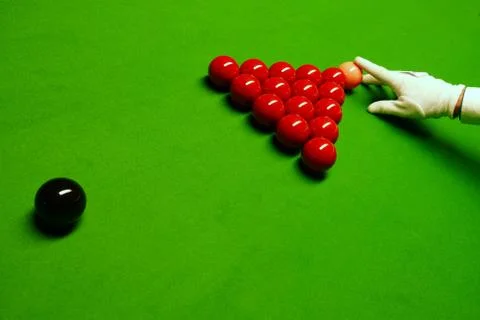 Snooker table and balls with referee arranging the balls Stock Photos