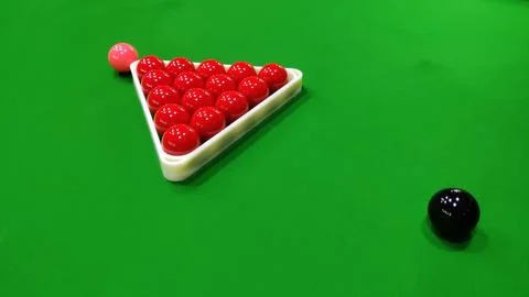 A snooker table with red balls in a triangle and a black and pink ball Stock Photos