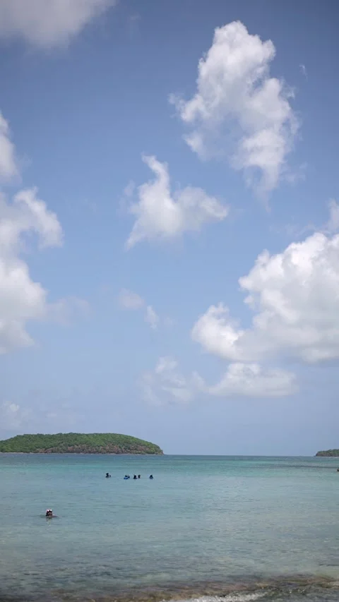 Snorkelers float in calm waters at Playa Sardinas, Culebra Stock Footage 327698175