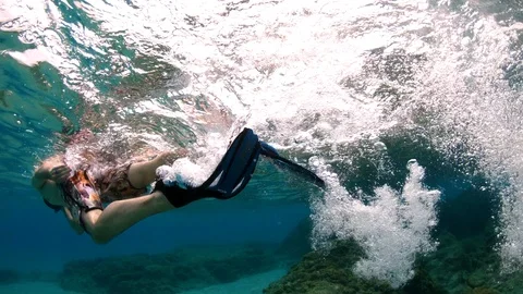Snorkeling man kicking and making lots of bubbles in Hawaii 4K slow motion Stock Footage