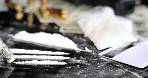 Snorting a line of cocaine with a rolled dollar bill, slow motion Stock Footage 318492589