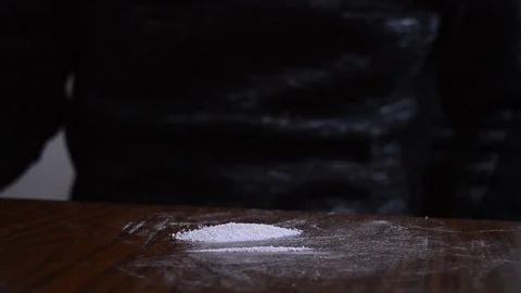 Snorting narcotics with a dollar bill, preparing lines of drug with a card Stock Footage 102526953