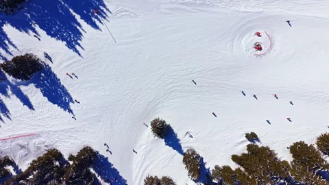 Snow activity takes place on a mountain with people skiing and snowboarding Stock Footage 335410358