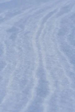 Snow after wind forms white canvas swirling patterns. Light, sparkling, wit.. Foto stock