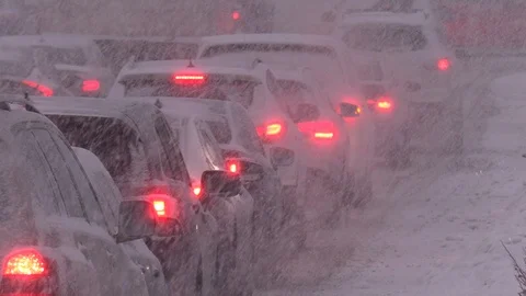 Snow and blizzard with rush hour traffic jam in the city Stock Footage 125508314