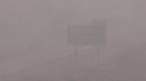 Snow and blowing snow with blizzard conditions on highway v15 Stock Footage 36596849