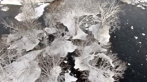 Snow and ice covered tiny islands in wide river Stock Footage 167671482