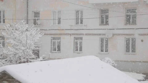 Snow and sleet falling on a window at Christmas time with rain drops. Cold wet Stock Footage 155454037