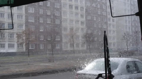 Snow and wind in the city in the spring afternoon on the background of houses an Stock-Footage 108849657