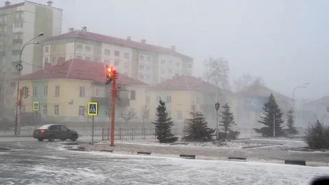 Snow and wind in the city in the spring afternoon on the background of houses an Stock-Footage 108849659