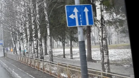 Snow and wind in the city in the spring afternoon on the background of houses an Stock-Footage 108849701