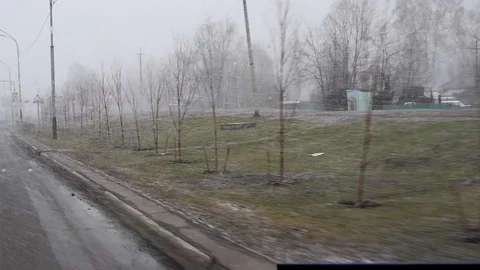 Snow and wind in the city in the spring afternoon on the background of houses an Stock-Footage 108849726