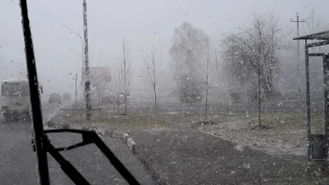 Snow and wind in the city in the spring afternoon on the background of houses an Stock-Footage 108849727