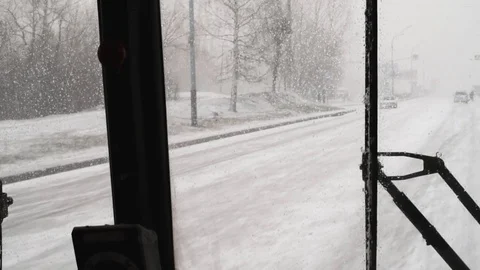 Snow and wind in the city in the spring afternoon on the background of houses an Stock Footage 111499696