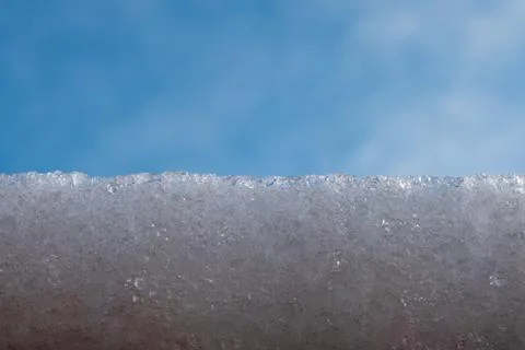 Snow on a background of blue sky. Stock Photos