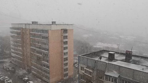 Snow on the background of a multi-storey building. Video stock 126635844