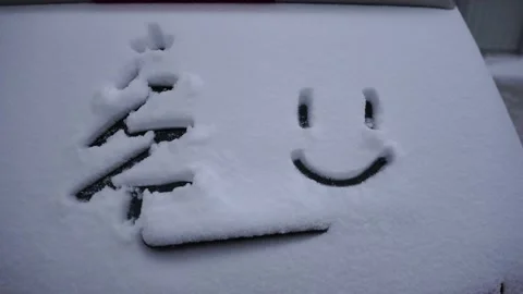 Snow background. Texture of wet snow with a cheerful smiley symbol pattern in Stock Footage 148099990