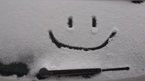Snow background. Texture of wet snow with a cheerful smiley symbol pattern in Stock Footage 148405989