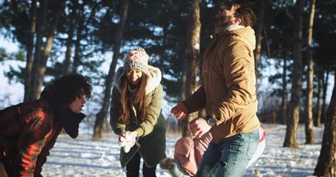 Snow ball time for a multi ethnic group of friends they play funny with the snow Stock Footage 111826202