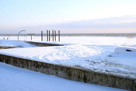 Snow on the beach during sunset. Winter landscape Stock Photos