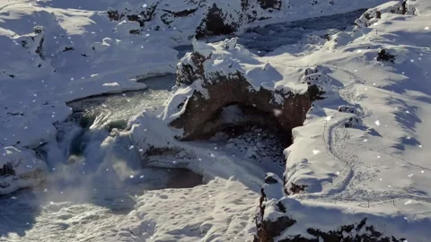Snow Begins Falling Over River Flowing Through Rocky Winter Canyon Stock Footage 325329173