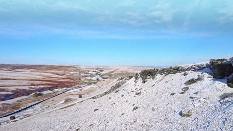 Snow blankets rocky cliffs under clear blue sky Vidéo 347273334