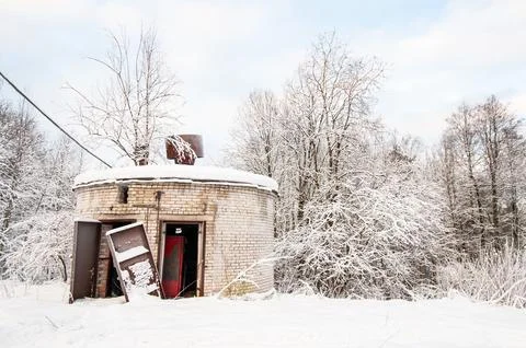 Snow blankets a round, brick structure. Trees stand bare and frosted nearby. Stock Photos