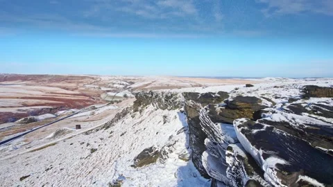 Snow blankets rugged cliffs under a clear blue sky Stock-Footage 347271746