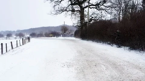 Snow blizzard blows across wintry road Stock Footage 97153058