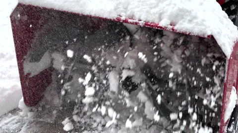 Snow blower being used to clear the driveway after a snow storm Stock Footage 144684660