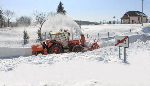 A snow blower breaks through a huge pile of snow Stock-Fotos