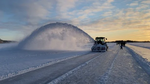 A snow blower clearing the ice road from snow in swedish lapland (4k, 60 fps) Stock Footage 123570945