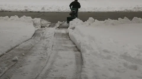 Snow blower driveway toward camera, snow to screen right Stock Footage 23115806