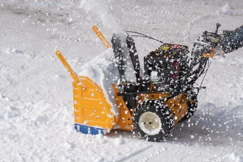 Snow blower machine is effectively removing snow from road after winter snow Stock-Fotos