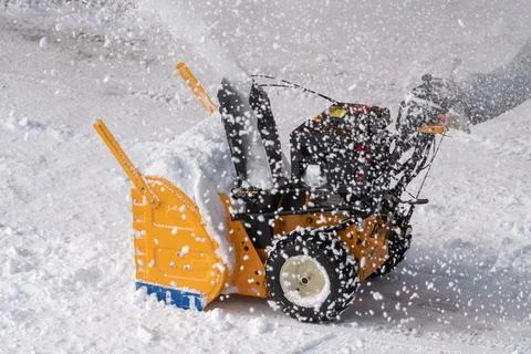 Snow blower machine is used to remove snow from driveway after snowy winter Stock-Fotos