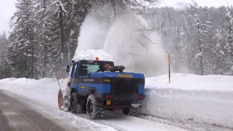 Snow blower removing snow from mountain road. Stock Footage 123786417