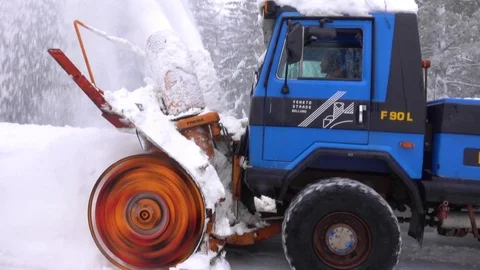 Snow blower removing snow from mountain road. Stock Footage 123786689