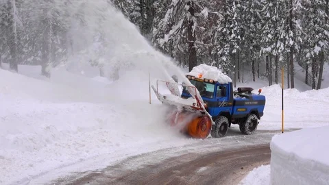 Snow blower removing snow from mountain road. Stock Footage 123786819