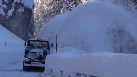 Snow blower removing snow from mountain road. Stock Footage 123786969