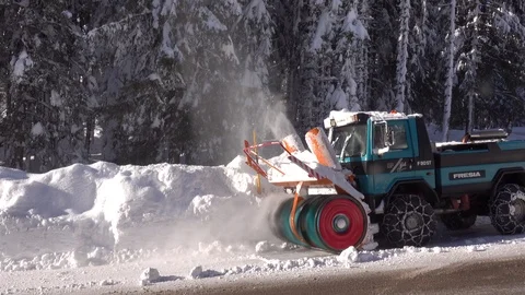 Snow blower removing snow from mountain road. Stock Footage 123787242